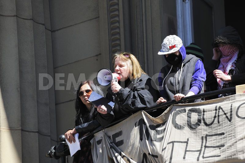 Juliet Edgar from a Facebook group 'ReClaim' delivers a powerful speech to the crowd gathered below explaining why they occupied the former Bank of England building on behalf of the homeless and why they are defying an eviction order.