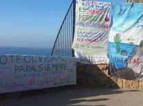  these are the banners in memory of Oussama who died here when he fell from the cliff trying to 'jump a boat' to Europe, the  'Prodein' kids rights group were fined 1500 euros for the action. 