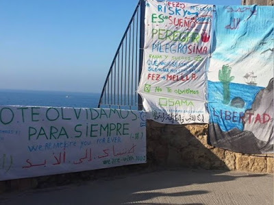  these are the banners in memory of Oussama who died here when he fell from the cliff trying to 'jump a boat' to Europe, the  'Prodein' kids rights group were fined 1500 euros for the action. 