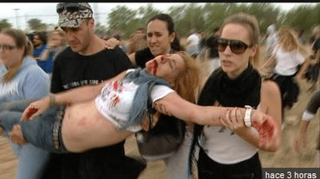anti buillfight activists save a wounded colleague after attack by pro bullfight mob at recent Toro de La Vega