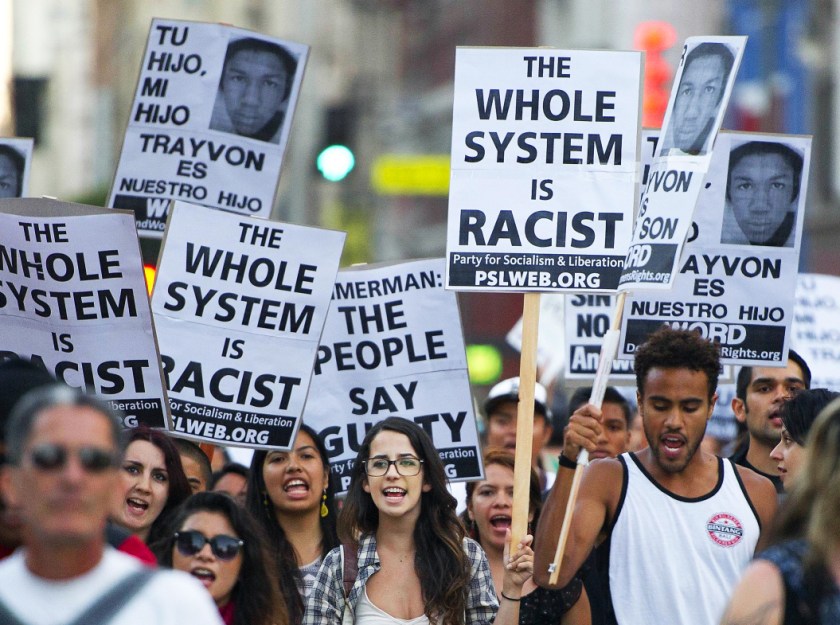Protestors angry at the acquittal of George Zimmerman in the death of black teen Trayvon Martin march through the streets of downtown Los Angeles, California July 16, 2013. A jury in Sanford, Florida last week found Zimmerman, a volunteer neighborhood watchman, not guilty of shooting dead Martin, a 17 year-old unarmed teen on the night of February 26, 2012. TOPSHOTS AFP PHOTO / ROBYN BECK