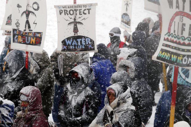 Veterans march with activists near Backwater Bridge just outside of the Oceti Sakowin camp during a snow fall as "water protectors" continue to demonstrate against plans to pass the Dakota Access pipeline adjacent to the Standing Rock Indian Reservation, near Cannon Ball, North Dakota, U.S., December 5, 2016.  REUTERS/Lucas Jackson
