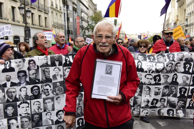 Demonstrators show photographs of Francoism victims during a demonstration in favour of Historical Memory in Madrid on November 22, 2015. Franco came to power after his side won Spain's 1936-39 civil war with the help of Germany's Adolph Hitler and Italy's Benito Mussolini. He then ruled Spain with an iron fist until his death on November 20, 1975. Forty years after the death of Francisco Franco, historians still work to demolish myths that the Spanish dictator spun about himself to hold on to power for decades. AFP PHOTO / JAVIER SORIANO