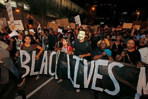 Marchers numbering nearly 1,000 take to the streets to protest against the recent fatal shootings of black men by police Friday, July 8, 2016, in Phoenix. Freeway ramps were closed and pepper spray and tear gas were used Friday night during a protest in downtown Phoenix following the killings of black men in Baton Rouge, Louisiana, and suburban St. Paul, Minnesota, at the hands of police and the deadly sniper attack on police officers in Dallas. (AP Photo/Ross D. Franklin)