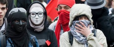 Protesters with their faces covered are shown during an anti-capitalist demonstration in Montreal, Tuesday, May 1, 2012. THE CANADIAN PRESS IMAGES/Graham Hughes