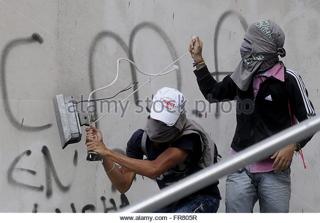 wo-hooded-protesters-destroy-a-security-camera-while-hundreds-of-fr805r.j