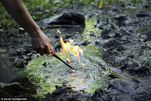 A farmer lights ground water bubbling up from a fresh water spring on his farm in Western Pennsylvania. The gas bubbles started one day after this property was fracked for natural gas extraction. The farmer's horses stopped drinking this water the day the bubbles appeared. This spring flows into a creek which feeds a larger river.